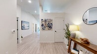 Located at 19501 E 31st Terrace in Independence, Missouri, this single-floor, 2-bedroom, 2-bathroom home offers a thoughtfully designed layout with modern finishes and a bright, airy ambiance throughout. Light-toned luxury vinyl plank flooring flows through the main living areas, complemented by neutral walls and recessed lighting.

The open-concept kitchen is a standout feature, boasting white shaker cabinetry, dark granite countertops, stainless steel appliances, and a peninsula with bar seating — ideal for casual dining and entertaining. Vaulted ceilings in the kitchen and dining area amplify the sense of space. The living room is warm and inviting, with a large window that floods the area with natural light.

The primary bedroom is generously sized and features plush carpeting, a ceiling fan, and a walk-in closet outfitted with wire shelving for ample storage. The en-suite bathroom includes white cabinetry with a granite-topped vanity and light wood-look tile flooring. The second bathroom conveniently doubles as a laundry room, housing a full-size washer and a tub-shower combination. The second bedroom also features carpet and easy access to the main living areas. A welcoming entryway with a window and decorative accents completes this clean, move-in-ready home.