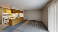 Located at 507 E Marion Rd in Wichita, KS, this one-bedroom, one-bathroom unit offers a compact and efficiently designed single-floor layout. The combined kitchen and living area forms the heart of the space, where a pass-through breakfast bar with a double stainless steel sink separates the kitchen from the carpeted living room. The kitchen is equipped with wood-tone cabinetry, overhead storage, a white range, and a full-size refrigerator, providing functional workspace for everyday cooking. The living room receives natural light through a large sliding glass door fitted with vertical blinds, which opens to an outdoor view and lends an open, airy feel to the area.

The bedroom is a comfortable, carpeted room featuring dual sliding-door closets that offer generous storage space, along with a window that brings in additional natural light and exterior views. Neutral wall tones and textured ceilings are consistent throughout the unit, contributing to a clean, understated aesthetic. The bathroom includes a full tub-shower combination, a toilet, wood-tone overhead cabinetry, and durable wood-look flooring. A dedicated laundry area adds convenience to the overall layout, making this a well-rounded and practical living space.