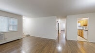 This 2-bedroom, 1-bathroom residence at 14 Vermeer Dr in South Amboy, NJ offers a practical and well-organized single-floor layout. Warm hardwood flooring runs throughout the main living areas and bedrooms, lending a cohesive and inviting feel to the space. The open living room is bright and clean, featuring white walls, baseboard heating, and a chandelier overhead that adds a simple decorative touch. It flows naturally into a dedicated dining area, creating a comfortable space for everyday living and entertaining. The kitchen is equipped with warm-toned wood cabinetry, dark countertops, a subway tile backsplash, and white appliances including a range, over-the-range microwave, and dishwasher, all set atop light tile flooring. A hallway connects the living spaces to the two bedrooms, both of which continue the hardwood flooring and feature clean white walls and baseboard heating. The spacious primary bedroom offers generous room for furnishings. The full bathroom includes a soaking tub with white tile surround and a window that allows natural light. With five closets distributed throughout, storage is plentiful. The entrance provides a convenient transition into the home's thoughtfully arranged floor plan.
