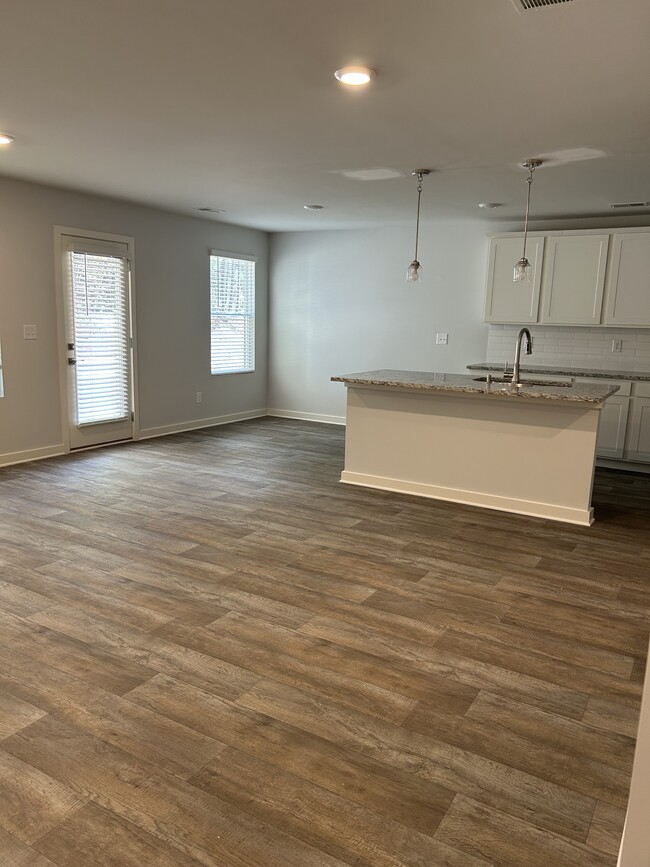 From the living room, looking at the kitchen. To the left of the kitchen is the dining area. - 226 River Meadow Dr