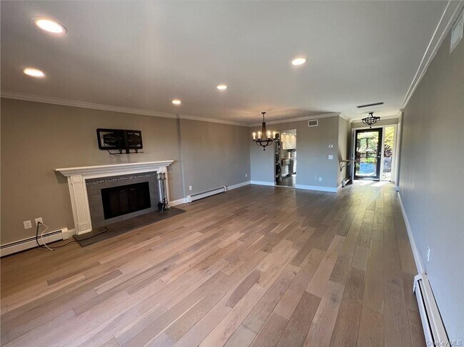 Beautiful open concept living room with tons of natural light from front door and balcony. - 1205 Eagle Bay Dr