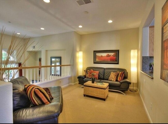 Building Photo - UPGRADED TOWNHOME IN RIVERMARK SOUGHT-AFTER WALK-UP SETTING