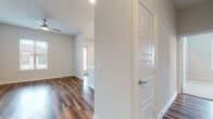 This well-designed single-floor residence offers a thoughtful layout that balances open communal spaces with comfortable private areas. The open-concept kitchen and living area serves as the heart of the home, showcasing rich hardwood-style flooring that flows seamlessly throughout the main living spaces. The kitchen is equipped with dark espresso cabinetry reaching to the ceiling, stainless steel appliances including a French door refrigerator, electric range, and built-in microwave, all complemented by a crisp white quartz countertop. A central island with pendant lighting and an undermount sink provides both additional prep space and a natural gathering point. Multiple windows fitted with blinds allow natural light to fill the living area, creating a bright and airy ambiance. The bedrooms feature plush carpeting and ceiling fans, with generous natural light from large windows. A spacious walk-in closet with wrap-around shelving and hanging rods offers ample storage. The bathrooms are finished with dark vanity cabinetry, white quartz countertops, framed mirrors, and tiled tub-shower combinations, all set atop warm hardwood-style flooring. Clean neutral wall tones and recessed lighting throughout lend the entire space a modern, cohesive feel.