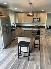 Kitchen with eat-in  granite islandisland - 6601 W 141st Ave