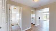 Located at 77 South Adams Street in Denver's desirable 80209 zip code, this single-floor residence offers a well-proportioned layout encompassing one bedroom, two bathrooms, two living areas, a kitchen, dedicated closet space, and three connecting hallways. The expansive main living room is a standout feature, boasting gleaming hardwood-style flooring, a striking white brick fireplace, a ceiling fan, and a large sliding glass door that floods the space with natural light and opens to outdoor views of the Denver cityscape. A second living area with soft carpeting and a generous window provides a versatile retreat. The galley-style kitchen is outfitted with crisp white cabinetry, light stone countertops, a subway tile backsplash, and stainless steel appliances, all set over hardwood-style flooring. The spacious primary bedroom features plush carpet, a bifold closet, and ample room to furnish comfortably. Two bathrooms serve the residence — one featuring a full tub and shower combination with clean white tile, and the other a well-appointed vanity with marble-style countertop and hardwood-style flooring. Neutral warm-toned walls and consistent finishes throughout create a cohesive, inviting ambiance.