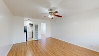 Located at 345 S Westlake Ave in Los Angeles, this efficient single-floor, one-bedroom, one-bathroom unit offers a practical and well-organized layout. The living room serves as the heart of the space, featuring warm-toned hardwood-style flooring, crisp white walls, and a ceiling fan with integrated lighting. A window unit provides climate control, and a large window allows natural light to fill the room while offering outdoor views.

The kitchen is thoughtfully equipped with white cabinetry, marble-style countertops, a stainless steel gas range, and an over-the-range microwave, providing a clean and functional cooking environment.

The bedroom is a cozy, light-filled retreat with the same warm flooring found throughout, white walls, and a window fitted with blinds for privacy and light control. Its compact footprint makes efficient use of space.

The bathroom is finished in an all-white palette, featuring a shower/tub combination with gold-toned fixtures, a toilet, vanity, and a small frosted window that brings in natural light while maintaining privacy.

Rounding out the unit is a dedicated laundry area, adding everyday convenience. The consistent use of light tones and natural-finish flooring throughout gives this unit a clean, cohesive, and inviting ambiance.