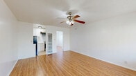 Located at 345 S Westlake Ave in Los Angeles, this efficient single-floor, one-bedroom, one-bathroom unit offers a practical and well-organized layout. The living room serves as the heart of the space, featuring warm-toned hardwood-style flooring, crisp white walls, and a ceiling fan with integrated lighting. A window unit provides climate control, and a large window allows natural light to fill the room while offering outdoor views.

The kitchen is thoughtfully equipped with white cabinetry, marble-style countertops, a stainless steel gas range, and an over-the-range microwave, providing a clean and functional cooking environment.

The bedroom is a cozy, light-filled retreat with the same warm flooring found throughout, white walls, and a window fitted with blinds for privacy and light control. Its compact footprint makes efficient use of space.

The bathroom is finished in an all-white palette, featuring a shower/tub combination with gold-toned fixtures, a toilet, vanity, and a small frosted window that brings in natural light while maintaining privacy.

Rounding out the unit is a dedicated laundry area, adding everyday convenience. The consistent use of light tones and natural-finish flooring throughout gives this unit a clean, cohesive, and inviting ambiance.