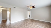 Located at 4010 Linkwood Dr in Houston's 77025 area, this single-story, 3-bedroom, 4-bathroom home offers a well-organized layout across one floor. The living room greets you with warm wood-look flooring, a ceiling fan with light fixture, and large windows that invite ample natural light, creating an open and airy atmosphere. The space flows seamlessly into the dining room and kitchen, where you'll find stainless steel appliances, including a range and over-the-range microwave, complemented by gray cabinetry, granite-style countertops, and a classic white subway tile backsplash. A pantry adds convenient storage to the kitchen area. Each of the three bedrooms features plush carpeting, ceiling fans, and windows with blinds that provide natural light and privacy. The generously sized primary bedroom includes multiple windows and direct access to one of the four bathrooms. The bathrooms are finished in a clean, modern style with white subway tile tub surrounds, wood-look flooring, and bright, functional fixtures. Five closets throughout the home ensure ample storage. Neutral wall tones and consistent finishes throughout give the home a cohesive, move-in-ready feel.