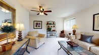 This well-appointed one-bedroom, one-bathroom residence in Bloomingdale, Illinois offers a comfortable and efficiently designed single-floor layout. The inviting living room is a standout feature, finished with plush wall-to-wall carpeting and a ceiling fan overhead. Natural light filters in through vertical blinds, and a sliding glass door opens to an outdoor patio area, bringing in views of surrounding greenery. The space is well-suited for relaxed living and entertaining.

The galley-style kitchen is positioned just off the entry hallway and features light wood cabinetry, dark granite-style countertops, tile flooring in a classic diamond pattern, and white appliances including a refrigerator and stove. The layout makes efficient use of the available space, with cabinetry lining both sides of the kitchen.

The bedroom is a comfortable retreat with plush carpeting, a large sliding-door closet, and a window that brings in natural light and outdoor views. The full bathroom includes a wood-vanity with under-sink storage, a tiled tub-shower combination, and tile flooring. A connecting hallway with tile flooring ties the rooms together, providing a clean and functional transition through the home.