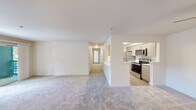 Located in Puyallup, WA, this single-floor home offers four bedrooms and two bathrooms within a thoughtfully designed layout. The open living room is a welcoming centerpiece, featuring a tile-surround fireplace, plush carpet, and a sliding glass door that opens to an outdoor balcony, allowing natural light to fill the space. The galley-style kitchen is equipped with stainless steel appliances—including a refrigerator, electric range, and microwave—complemented by light wood cabinetry, white countertops, and easy-care hardwood-style flooring. A pantry closet provides additional storage just off the kitchen. The living and kitchen areas flow seamlessly, connected by an open pass-through that enhances the sense of openness. Each of the four bedrooms features soft carpeting and windows that bring in natural light, with the bedrooms offering a calm, neutral palette. A dedicated closet provides well-organized wire-rack shelving for storage. The two bathrooms are finished with light wood vanities, white countertops, large mirrors, and one includes a full soaking tub with shower. A central hallway connects all rooms efficiently, completing this practical and comfortable home.