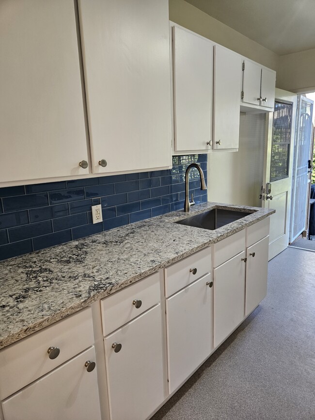 New quartz countertop & glass tile backsplash - 5058 Colfax Ave