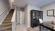 Located in Mt. Juliet, Tennessee, this three-story, 4-bedroom, 3-bathroom home offers a thoughtfully designed layout with warm, neutral tones and a blend of hardwood and tile flooring throughout. The main floor serves as the heart of the home, featuring an open living and dining area bathed in natural light. The living room boasts rich hardwood floors, a stylish pendant light fixture, and a staircase that connects all three levels with clean, white railings. The adjacent dining area comfortably accommodates formal gatherings, while the kitchen impresses with white shaker cabinetry, granite countertops, subway tile backsplash, and black appliances. A convenient half bathroom with a pedestal sink completes this level. Upstairs, the primary bedroom offers a serene retreat with plush carpeting, natural light from multiple windows, and a dedicated closet. Additional bedrooms are well-sized with closets and windows providing ample light. The bathrooms feature tile flooring, granite vanities, and tasteful finishes. The lower level provides versatile flex space, ideal as a home office or study, complete with tile flooring and staircase access. Throughout, the home maintains a cohesive, neutral palette that balances comfort and sophistication.