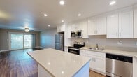 Located at 37950 Fremont Blvd in Fremont, CA, this single-floor, one-bedroom, one-bathroom unit offers a well-designed layout with modern finishes throughout. The kitchen is a standout feature, showcasing crisp white shaker cabinets, quartz countertops, a central island, and a full suite of stainless steel appliances including a refrigerator, range, microwave, and dishwasher. Recessed lighting and wood-look plank flooring complete the bright, contemporary feel of this space.

The living room is open and inviting, featuring matching hardwood-style flooring, a ceiling fan, and a sliding glass door that floods the room with natural light and provides access to an outdoor balcony with views of the surrounding neighborhood.

The bedroom offers plush carpeting, a ceiling fan, two closets for ample storage, and a window overlooking the outdoors. Neutral wall tones create a calm and comfortable atmosphere throughout.

The bathroom is cleanly appointed with a granite-topped vanity, a full tub/shower combo with brushed nickel fixtures, a mirror, and wood-look flooring that ties the space together cohesively. Overall, the unit presents a clean, move-in-ready aesthetic with modern upgrades.