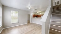 Located at 1694 Baldwin Park Dr in Tallahassee, FL, this two-story home offers four bedrooms and four bathrooms spread across a thoughtfully designed layout. The main floor provides an open, airy feel with light hardwood-style flooring, neutral toned walls, and a ceiling fan that enhances the comfortable living area. Natural light flows in through multiple windows with views of the surrounding greenery. The staircase rises prominently from the living area, leading to the upper level.

The kitchen is well-equipped with rich warm-toned cabinetry, granite-style countertops, stainless steel appliances including a range, microwave, refrigerator, and dishwasher, and a peninsula that opens toward the living space. Pendant lighting above the counter adds a functional and decorative touch.

Each of the four bedrooms features light wood-style flooring, ceiling fans, and ample closet space, including mirrored sliding-door closets in select rooms. The primary bedroom includes its own dedicated closet and private bathroom access. The bathrooms are consistently finished with matching cabinetry, granite-style countertops, and tub-shower combinations. Five closets throughout the home ensure abundant storage. The upper level houses additional bedrooms, each with corner windows offering pleasant outdoor views.