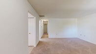 Located at 8800 Howard Hills Dr in Savage, MD, this single-story home offers a practical and functional layout across four bedrooms and two bathrooms. The interior is finished with neutral white walls and warm beige carpeting throughout the bedroom areas, creating a clean and versatile canvas.

The kitchen is well-equipped, featuring light wood cabinetry with ample upper and lower storage, laminate countertops, a gas range, dishwasher, and refrigerator. Natural light filters in through a window above the sink, and the tile flooring adds a durable, easy-to-maintain surface. An adjacent dining or living area benefits from additional windows that bring in views of the surrounding greenery.

The spacious primary bedroom offers generous square footage relative to the home's overall footprint, providing a comfortable retreat. The additional three bedrooms are well-sized, each with carpeted floors, natural light from windows with blinds, and ceiling light fixtures.

The two bathrooms are clean and functional. One features a tiled tub-shower combination with a light wood vanity and tile flooring, while the second is a half-bath style with a single vanity and toilet. Both maintain a bright, neutral aesthetic consistent with the rest of the home. Overall, the space presents a tidy, move-in ready atmosphere suited for practical everyday living.