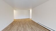 Located at 500 Glenelm Crescent in Waterloo, Ontario, this well-appointed one-bedroom, one-bathroom unit offers a thoughtfully designed layout across a single floor. The space is finished with light wood-tone laminate flooring throughout, crisp white walls, and baseboard heating, creating a clean and cohesive aesthetic.

The kitchen is a standout feature, showcasing white shaker-style cabinetry, dark countertops, a classic white subway tile backsplash, a stainless steel double sink with a modern chrome faucet, and a dishwasher — combining style with everyday practicality.

The spacious living room is bright and open, benefiting from a sliding glass door that leads directly to a private balcony with outdoor views of greenery. An additional window further enhances the flow of natural light into the living area.

The bedroom offers a comfortable and quiet retreat, featuring a wide sliding-door closet for ample storage, a large picture window overlooking a natural landscape, and the same warm flooring found throughout the unit.

The bathroom is finished to a high standard, with grey tile flooring, a full-size soaker tub and shower enclosed in white subway tile, a modern vanity with an integrated sink, and clean chrome fixtures. A hallway connects all rooms, completing this functional and stylish home.