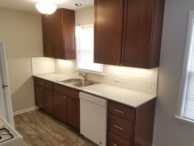 Granite counters, dishwasher, extra tall upper cabinets for storage, over range microwave - 6617 Walrond Ave