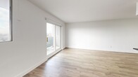 Located on the 8th floor at 86 Cedar St in Kitchener, Ontario, this one-bedroom, one-bathroom unit offers a thoughtfully designed layout with modern finishes throughout. Light wood laminate flooring runs continuously across the space, complementing the crisp white walls and clean, contemporary aesthetic.

The galley-style kitchen is well-appointed with white shaker cabinetry, dark countertops, white subway tile backsplash, and a full suite of stainless steel appliances including a refrigerator, electric range, over-the-range microwave, and dishwasher. The kitchen opens toward the living area, creating a functional flow between spaces.

The living room is bright and airy, featuring a sliding glass door that leads to a private balcony with sweeping views of the Kitchener cityscape and surrounding neighbourhoods. A secondary window further enhances natural light throughout.

The bedroom is a comfortable size, offering a large sliding-door closet and a window with city views. The hallway connects the rooms with efficient use of space.

The bathroom features a soaker tub with a full surround of classic white subway tile and chrome fixtures, maintaining the consistent clean and modern design language found throughout the unit. This well-appointed residence is an ideal urban home in the heart of Kitchener.