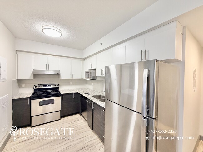 Photo du bâtiment - Modern 2-Bedroom Condo with Balcony in the...