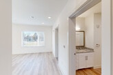 Located at 2597 Williams St in Chattanooga, TN, this well-designed one-bedroom, one-bathroom unit offers a clean, modern aesthetic across a thoughtfully laid-out single floor. Light wood-style flooring runs consistently throughout the space, creating a cohesive and airy feel from room to room.

The living room is bright and open, featuring large windows fitted with horizontal blinds that invite abundant natural light and offer outdoor views. A ceiling fan adds both function and character to the space. Adjacent to the living area, the kitchen is a standout feature, showcasing crisp white shaker-style cabinetry, granite countertops, a tile backsplash, and a full suite of stainless steel appliances including a refrigerator, range, and dishwasher. A large window above the sink further brightens this functional space.

The bedroom is a comfortable, well-proportioned retreat with its own window offering outdoor views and a ceiling fan overhead. Recessed lighting and clean white walls contribute to the room's fresh, modern character. The bathroom continues the refined aesthetic with white cabinetry, a granite-topped vanity, a framed mirror, and wood-style flooring. A separate water closet provides added privacy and practicality.