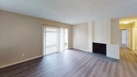 Located at 815 Wescove Pl in West Covina, California, this single-story residence presents a functional and well-maintained layout with updated finishes throughout. The living room serves as a central gathering space, featuring durable laminate wood flooring, a white-paneled fireplace surround, and a sliding glass door fitted with vertical blinds that opens to an outdoor area, allowing natural light to fill the room. An adjacent carpeted room with vertical panel wall detailing and its own sliding glass door offers flexible use as a bedroom or secondary living space.

The galley-style kitchen is outfitted with white shaker cabinetry, taupe countertops, a gas range, and a double-basin sink, providing ample storage and a clean, bright atmosphere. Bedroom areas feature plush carpeting and panel-accented walls, with one room including a generously sized walk-in closet equipped with dual hanging rods and shelving on both sides.

Two bathrooms serve the home. The full bathroom includes a combination tub and shower with glass sliding doors, decorative tile accents, a white vanity with a taupe countertop, and brushed nickel grab bars. A second, accessibility-focused bathroom features a wide open layout, grab bars, and a single-sink vanity. Light tile-style flooring runs through both bathrooms, contributing to a cohesive, contemporary feel throughout the home.