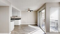 Located at 311 S Sunrise Way in sunny Palm Springs, California, this single-floor, one-bedroom, one-bathroom unit offers a clean, modern aesthetic throughout. Light-toned luxury vinyl plank flooring runs continuously across the entire space, lending a cohesive and contemporary feel.

The open living area is bright and generously proportioned, featuring recessed lighting, a textured ceiling, and direct access to an outdoor patio via a sliding glass door that invites abundant natural light. The kitchen is positioned adjacent to the living space and is outfitted with white cabinetry, dark countertops, and stainless steel appliances including a full-size refrigerator.

The spacious primary bedroom accommodates a ceiling fan and multiple windows fitted with horizontal blinds, allowing for ample natural light and ventilation. A sliding glass door in the bedroom also connects to the outdoor area. The unit includes two closets, providing practical storage solutions.

The bathroom is finished with a clean, white palette, featuring a full tub-shower combination, a white vanity with dark countertop, and wood-look flooring. A hallway connects the bedroom to the main living areas, creating a logical and comfortable flow throughout the unit. The overall ambiance is light, neutral, and move-in ready.