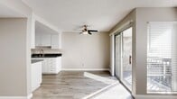 Located at 311 S Sunrise Way in sunny Palm Springs, California, this single-floor, one-bedroom, one-bathroom unit offers a clean, modern aesthetic throughout. Light-toned luxury vinyl plank flooring runs continuously across the entire space, lending a cohesive and contemporary feel.

The open living area is bright and generously proportioned, featuring recessed lighting, a textured ceiling, and direct access to an outdoor patio via a sliding glass door that invites abundant natural light. The kitchen is positioned adjacent to the living space and is outfitted with white cabinetry, dark countertops, and stainless steel appliances including a full-size refrigerator.

The spacious primary bedroom accommodates a ceiling fan and multiple windows fitted with horizontal blinds, allowing for ample natural light and ventilation. A sliding glass door in the bedroom also connects to the outdoor area. The unit includes two closets, providing practical storage solutions.

The bathroom is finished with a clean, white palette, featuring a full tub-shower combination, a white vanity with dark countertop, and wood-look flooring. A hallway connects the bedroom to the main living areas, creating a logical and comfortable flow throughout the unit. The overall ambiance is light, neutral, and move-in ready.