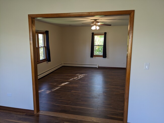 Large living room (17' x 19') with new flooring and ceiling fan. - 509 Algonquin Rd