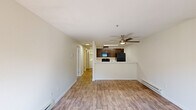 Located in Vancouver, WA, this efficiently designed one-bedroom, one-bathroom unit offers a thoughtful layout across a single floor. The open-concept living and dining area is a central highlight, featuring wood-look flooring, a ceiling fan, and baseboard heating, creating a comfortable and functional gathering space. The galley-style kitchen is well-appointed with dark espresso cabinetry, white countertops, black appliances including a refrigerator, range, microwave, and dishwasher, and a stainless steel sink — all accessible via a convenient pass-through counter.

The spacious bedroom is carpeted for comfort and features a natural light source from a window with blinds, along with baseboard heating. Two closets provide ample storage throughout the unit. The full bathroom includes a tub/shower combo with a curved curtain rod and wood-look tile flooring. A dedicated office space adds versatility for remote work or study needs.

The hallways are bright with flush-mount ceiling lighting and wood-look flooring, connecting all rooms seamlessly. A laundry area with a water heater is conveniently located within the unit. A private patio extends the living space outdoors, rounding out this well-organized and practical residence.