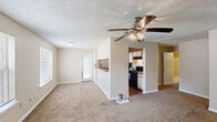 Located at 10624 Glenstone Ct in Baton Rouge, Louisiana, this single-story 2-bedroom, 2-bathroom home offers a practical and comfortable layout. The galley-style kitchen is efficiently designed with white cabinetry trimmed in wood tones, granite-look countertops, a gas range, and a black refrigerator, all set atop durable wood-look flooring. The kitchen opens directly into the living area, creating a connected flow throughout the main living space.

Both bedrooms feature soft, wall-to-wall carpeting and neutral beige walls with textured ceilings, lending a warm and understated feel. Each room benefits from natural light via windows with blinds. The primary bedroom includes direct access to a dedicated bathroom and a closet, offering added privacy and convenience.

The two bathrooms are clean and functional, each featuring wood-look flooring, white vanity cabinetry, granite-look countertops, a single sink, and a shower-tub combination with a curtain. The overall design maintains a consistent, neutral palette throughout, creating a cohesive and move-in-ready atmosphere. This home provides a straightforward, well-organized floor plan suited for comfortable everyday living in a residential Baton Rouge neighborhood.