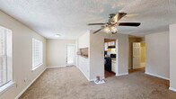 Located at 10624 Glenstone Ct in Baton Rouge, Louisiana, this single-story 2-bedroom, 2-bathroom home offers a practical and comfortable layout. The galley-style kitchen is efficiently designed with white cabinetry trimmed in wood tones, granite-look countertops, a gas range, and a black refrigerator, all set atop durable wood-look flooring. The kitchen opens directly into the living area, creating a connected flow throughout the main living space.

Both bedrooms feature soft, wall-to-wall carpeting and neutral beige walls with textured ceilings, lending a warm and understated feel. Each room benefits from natural light via windows with blinds. The primary bedroom includes direct access to a dedicated bathroom and a closet, offering added privacy and convenience.

The two bathrooms are clean and functional, each featuring wood-look flooring, white vanity cabinetry, granite-look countertops, a single sink, and a shower-tub combination with a curtain. The overall design maintains a consistent, neutral palette throughout, creating a cohesive and move-in-ready atmosphere. This home provides a straightforward, well-organized floor plan suited for comfortable everyday living in a residential Baton Rouge neighborhood.