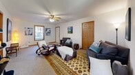 Located at 4213 Court Royale in Schenectady, NY, this single-floor, one-bedroom, one-bathroom home offers a thoughtfully organized layout across a comfortable footprint. The living room is a welcoming space featuring carpet flooring, a ceiling fan, natural light from a large window, and warm wood-trimmed doors that add a classic touch throughout the home. The bedroom provides a cozy retreat with carpet flooring, a window offering outdoor views, and ample room for furnishings. A dedicated office space offers a quiet area suitable for work or creative pursuits, complete with carpet flooring and neutral walls. The kitchen is outfitted with warm oak cabinetry, white appliances including a range and dishwasher, light countertops, a tile backsplash, and easy-care tile flooring. Conveniently adjacent to the kitchen, the dining area features tile flooring, a pendant light fixture, and a sliding glass door that opens to outdoor views, filling the space with natural light. In-unit stacked washer and dryer are also located in this area. The full bathroom includes an oak vanity, a large mirror, tile flooring, and a grab bar for added accessibility. Overall, the home presents a clean, functional, and comfortable living environment.