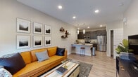 Located at 4555 Fallon Street in Bozeman, Montana, this single-floor residence offers a well-designed, modern living experience with a cohesive aesthetic carried throughout every room. The open-concept living and kitchen area serves as the heart of the home, where light wood-style flooring, recessed lighting, and neutral walls create a bright, welcoming atmosphere. The living room provides ample space for relaxing and entertaining, featuring a large window with natural light and views of the outdoors. The kitchen is outfitted with dark espresso cabinetry, white quartz countertops, stainless steel appliances, a tiled backsplash, and a peninsula with bar seating. A dedicated walk-in pantry offers generous storage. The primary bedroom is a comfortable retreat with room for a king-sized bed, complemented by natural light from a large window. The en-suite bathroom features a dual-sink vanity with dark cabinetry, a backlit mirror, and a glass-enclosed walk-in shower with wood-look flooring. A second bedroom is equally well-appointed, also benefiting from natural light. A second full bathroom includes a soaking tub with tiled surround. Consistent wood-style flooring and clean architectural lines unify the space throughout.