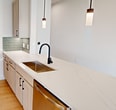 This contemporary apartment in Upper Kirby offers 1050 square feet of thoughtfully designed living space. The unit boasts two bedrooms and two bathrooms, with the primary bedroom spanning a generous 170 square feet. Both bathrooms feature a modern aesthetic with marble-look tiled walls, glass shower enclosures, and sleek fixtures. The open-concept living area is highlighted by warm wood flooring and bathed in natural light from large windows, which also provide city views. A modern kitchen with pendant lighting and a breakfast bar opens to the living space, perfect for entertaining. Each bedroom is equipped with a ceiling fan for comfort and includes a closet with wire shelving for ample storage. The apartment's neutral color palette and clean lines create a fresh, inviting ambiance throughout. Additional features include recessed lighting, a full-size washer and dryer hookup, and energy-efficient appliances, making this Upper Kirby residence a perfect blend of style and functionality.