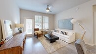 Located at 201 Kenbrook Way in Davenport, Florida, this single-story 2-bedroom, 2-bathroom residence offers a thoughtfully designed layout with a clean, contemporary aesthetic. The open-concept kitchen and living area serves as the heart of the home, featuring dark wood-grain cabinetry that reaches to the ceiling, white quartz countertops, stainless steel appliances including a French door refrigerator, electric range, and built-in microwave, along with a kitchen island with an undermount sink. Light wood-look flooring flows through the main living areas, creating a bright and cohesive feel. The living room provides a comfortable, open space with natural light and access to the outdoors. The primary bedroom is generously sized, fitted with plush carpet, multiple windows with blinds, and a ceiling fan. Its en-suite bathroom includes a single-sink vanity with dark cabinetry and white countertops, and leads directly into a spacious walk-in closet with wire shelving. The second bedroom is well-proportioned with carpet flooring and its own closet. The second bathroom features a tub-shower combination, matching dark vanity cabinetry, and white countertops. A dedicated laundry room houses a full-sized washer and dryer. The hallway connects all rooms efficiently, completing this functional and stylish floor plan.
