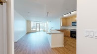 Located in the heart of downtown Phoenix, this 1-bedroom, 2-bathroom unit offers a well-designed open-concept layout with modern finishes throughout. Light hardwood flooring runs continuously across the main living areas, complementing the clean, contemporary aesthetic.

The combined kitchen and living area forms the centerpiece of the space. The kitchen is equipped with warm maple cabinetry, granite countertops, black appliances including a gas range, built-in microwave, and refrigerator, and a large peninsula island with an undermount sink and pendant lighting overhead — ideal for both meal preparation and casual dining.

The living room is bathed in natural light from expansive floor-to-ceiling windows and glass doors that frame views of the Phoenix skyline, creating a bright and open atmosphere.

The generously sized primary bedroom features large windows with city views, light hardwood floors, and access to two closets, including a walk-in with wire shelving. The primary bathroom is a standout, offering a dual-sink vanity with ample cabinetry, large-format tile flooring, a soaking tub, and a separate glass-enclosed shower. A second full bathroom provides added convenience for guests.

This downtown unit delivers a polished urban living experience with practical amenities and abundant natural light.