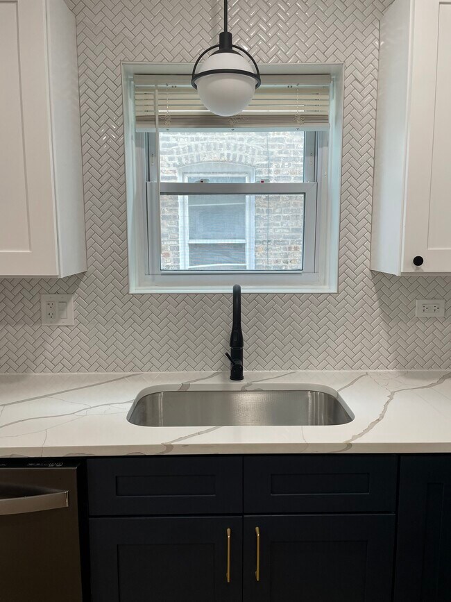 Quartz countertops and decorative light fixture - 1017 N Harlem Ave