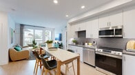 Located in the vibrant North Park neighborhood of San Diego, this thoughtfully designed 2-bedroom, 3-bathroom residence offers a bright, modern living experience on a single floor. The open-concept kitchen and dining area is anchored by sleek white cabinetry, dark countertops, a textured geometric tile backsplash, and stainless steel appliances — all complemented by light wood-tone flooring that flows throughout. Recessed lighting enhances the clean, contemporary aesthetic. The living room is bathed in natural light from large sliding glass doors that open to a private balcony with outdoor views, creating a seamless indoor-outdoor connection. The primary bedroom is a generous, serene retreat with direct balcony access and a well-appointed walk-in closet featuring built-in shelving and double hanging rods. A second bedroom impresses with a bold botanical accent wall, its own balcony access, and a spacious walk-in closet. The three bathrooms are finished with modern vanities and dark countertops; one features elegant marble-style tile surrounding a soaking tub and shower combo with brushed gold fixtures. The residence includes a total of three closets, providing ample storage throughout. Crisp white walls and abundant natural light give the entire home a fresh, airy ambiance.