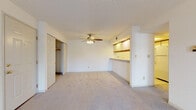 Located at 3501 Lakeshore Rd in Sheboygan, Wisconsin, this single-story unit offers a functional and straightforward layout designed for comfortable everyday living. The main living area is generously sized, featuring neutral-toned carpet, a ceiling fan with light fixture, and a textured ceiling. A built-in pass-through counter with illuminated upper cabinetry connects the living space to the kitchen, adding both practicality and visual interest.

The galley-style kitchen is efficiently organized, with cream-toned cabinetry featuring wood-trim accents lining both walls. It includes a double-basin sink, electric range, dishwasher, and refrigerator, all set on light vinyl flooring. Upper and lower cabinet storage is ample throughout.

The bedrooms are carpeted and bright, each benefiting from natural light through windows fitted with blinds. Ceiling fans are present in multiple rooms, and closet space is well-represented, including a walk-in closet with shelving and rod storage, as well as additional sliding-door and standard-door closets in other bedrooms.

The bathroom features a wide vanity with a large mirror, wood-accented cabinetry below, and light tile flooring. The overall aesthetic throughout is clean and neutral, providing a versatile canvas for personalization.