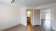 Located at 6405 Rossi Dr in Columbus, Ohio, this two-floor home offers a well-organized layout with practical finishes throughout. The main living area features hardwood-style flooring and a sliding glass door fitted with vertical blinds, allowing abundant natural light and providing access to the outdoors. The kitchen is equipped with stainless steel appliances — including a refrigerator, electric range, and over-the-range microwave — complemented by light wood cabinetry, dark countertops, and a breakfast bar, all set on matching hardwood-style flooring. A dedicated laundry area on the lower level accommodates a full-size washer and dryer with wire shelving above for additional storage. The bathrooms feature dark countertops with warm wood vanity cabinets; one bathroom includes a tub-shower combination, while another serves as a half bath with a single vanity and mirror. The bedrooms are carpeted for comfort and receive natural light through blinds-fitted windows. The primary bedroom connects directly to a bathroom, offering added convenience. Throughout the home, clean white walls, panel-style doors, and consistent finishes create a cohesive, move-in-ready environment across both floors.