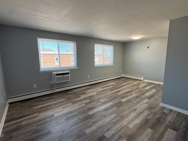 Living room facing dining area - 109 S Main St Apartments