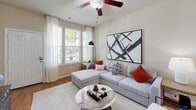 Located in Estero, Florida, this single-story 2-bedroom, 2-bathroom home offers a thoughtfully designed layout that maximizes comfort and functionality. The open-concept living, dining, and kitchen area serves as the heart of the home, with hardwood-style flooring, neutral-toned walls, and a ceiling fan that enhances airflow throughout. Large windows flood the living room with natural light, offering pleasant outdoor views and a bright, welcoming ambiance.

The kitchen is equipped with dark espresso cabinetry, granite-style countertops, black appliances, and a breakfast bar with pendant lighting overhead — ideal for casual dining or entertaining. A built-in wine rack adds a distinctive touch to the cabinetry.

The primary bedroom features carpeted flooring, large windows that invite natural light, and ample closet space. The second bedroom is equally comfortable, with a ceiling fan and cozy atmosphere. Both bathrooms are finished with wood-style flooring, dark vanity cabinetry, and a tub-shower combination. The dedicated laundry room houses a full-size washer and dryer. With four closets throughout, storage is plentiful in this efficiently designed Estero residence.