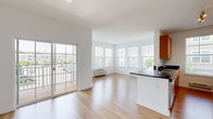 Located at 1828 Parkview Dr in Roselle, NJ, this well-appointed 2-bedroom, 2-bathroom single-floor residence offers a bright and functional layout. The open-concept living and kitchen area is a standout feature, filled with natural light from expansive windows and a sliding glass door that leads to a private balcony with outdoor views. Light-toned hardwood-style flooring runs throughout the main living areas, enhancing the airy, modern feel of the space.

The kitchen is equipped with warm-toned wood cabinetry, dark granite countertops, stainless steel appliances including a refrigerator, range, and built-in microwave, and a peninsula that provides additional prep space and a natural divide from the living area.

Both bedrooms are carpeted and feature individual HVAC units and windows with blinds that allow for controlled natural light. The generously sized primary bedroom offers a comfortable retreat. The two bathrooms are clean and contemporary — one features a sleek glass-enclosed walk-in shower with subway tile, while the second includes a soaking tub/shower combination, both appointed with warm wood vanities and tile flooring.

A utility closet with a water heater and additional storage complete this well-organized and thoughtfully designed residence.