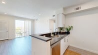 Located at 3518 Chesapeake Ave in Los Angeles, CA, this thoughtfully designed single-floor unit offers three bedrooms and two bathrooms within a well-utilized layout. Light wood-style flooring flows consistently throughout, lending warmth and visual continuity to every room.

The open living area is bright and airy, with recessed lighting, neutral walls, and a sliding glass door that opens to a private balcony overlooking the surrounding neighborhood — an ideal spot to enjoy the Southern California outdoors.

The kitchen features a clean, modern aesthetic with white cabinetry, dark countertops, and stainless steel appliances including a full-size refrigerator and range. Ample upper and lower cabinet storage makes the space both functional and efficient.

The primary bedroom is generously sized and includes a louvered interior door, adding a stylish detail. The additional bedrooms are bright and well-proportioned, each featuring large windows with vertical blinds that allow for natural light and privacy.

Both bathrooms are finished in a crisp, contemporary style with white fixtures, tub-shower combinations with curved curtain rods, and white cabinetry. One bathroom features a dark countertop vanity for added contrast. A connecting hallway ties all rooms together seamlessly, completing this well-appointed home.