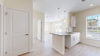 Located at 22 Summit Place in Branford, CT, this thoughtfully designed two-bedroom, two-bathroom residence offers a bright and functional single-floor layout. The open-concept living, dining, and kitchen area serves as the heart of the home, featuring light wood-style flooring, crisp white cabinetry, granite countertops, and a central kitchen island with a built-in sink and elegant pendant lighting overhead. Recessed lighting and large windows with blinds allow natural light to flood the space, creating a clean and airy atmosphere throughout.

The spacious primary bedroom offers generous proportions, a wall-mounted mini-split system for personalized climate control, and a large window overlooking the neighborhood. A well-appointed walk-in closet with wire shelving provides ample storage. The second bedroom is equally bright, benefiting from similar natural light and neutral finishes. Both bathrooms feature tile flooring and clean, functional fixtures. Altogether, the unit includes five closets, offering exceptional storage throughout.

The overall aesthetic is modern and neutral, with warm beige tones, white trim, and light flooring creating a cohesive and welcoming environment. This move-in-ready residence combines practical design with bright, open spaces ideal for comfortable everyday living.