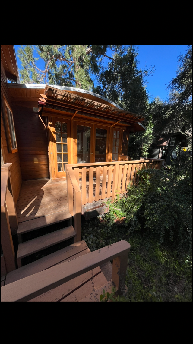 Front of studio with deck, walkway to parking on the left and small yard to the right. - 1417 Old Topanga Canyon Rd