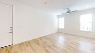 Located in Corinth, TX, this two-story home features a clean, modern design with light-toned finishes throughout. The ground floor houses the main living areas, including a kitchen and living room combination with light wood-look flooring. The kitchen is outfitted with white shaker cabinetry, granite countertops, a central island with a built-in sink, subway tile backsplash, and stainless steel appliances. An attached garage with an automatic opener provides direct interior access.

The upper floor is more expansive and accommodates all four bedrooms, connected by hallways with the same light wood-look flooring. Bedrooms feature neutral carpet, ceiling fans, and windows that bring in natural light. The primary bedroom includes a walk-in closet with built-in shelving and rods, along with a private en-suite bathroom featuring a dual-sink granite vanity, large mirror, and a separate shower. Secondary bathrooms are finished with granite countertops, white cabinetry, and tiled tub-shower combinations. A dedicated laundry room with side-by-side washer and dryer hookups adds everyday convenience. The overall palette is bright and neutral throughout.