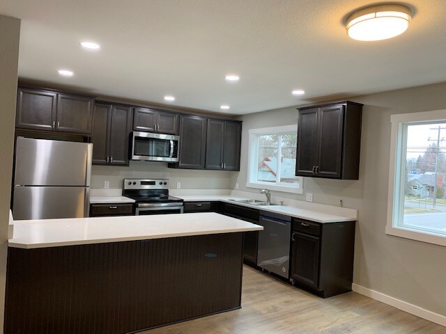 New kitchen with abundant cabinets and bar area - 1503 E Mullan Ave