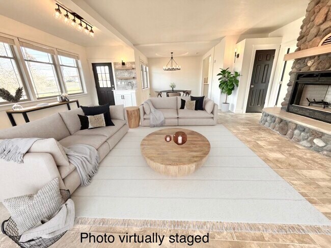 Virtually staged living room looking into dining. Door on left to exterior deck. - 24 Ash St N