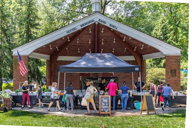A charming farmers' market set against a verdant backdrop.